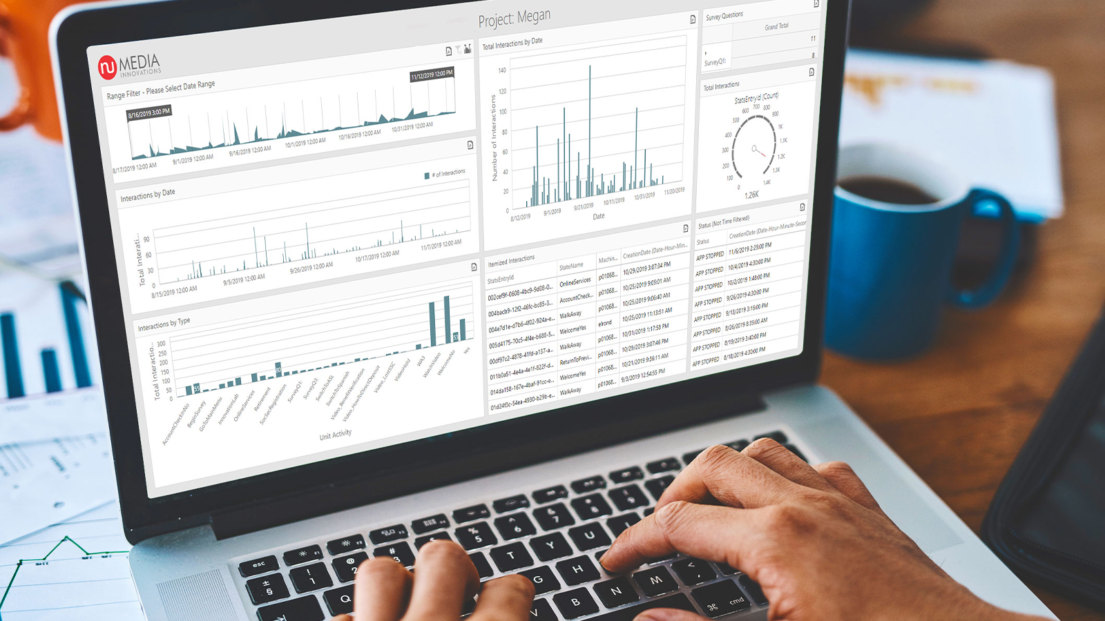 someone typing on a laptop, numedia innovations logo is on the screen as well as data and analytics
