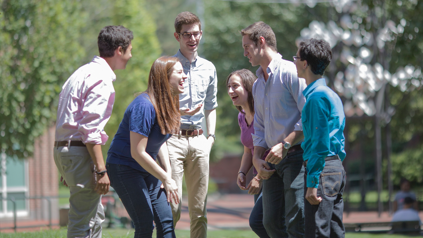 young people in a circle laughing