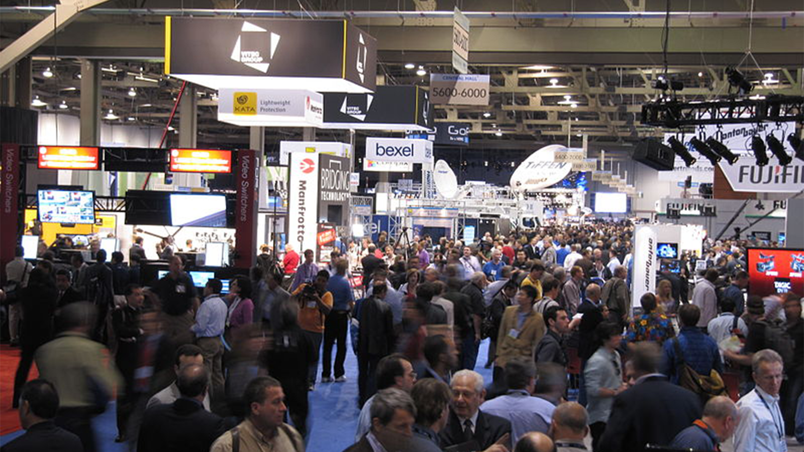 trade show floor, lots of people and logos everywhere